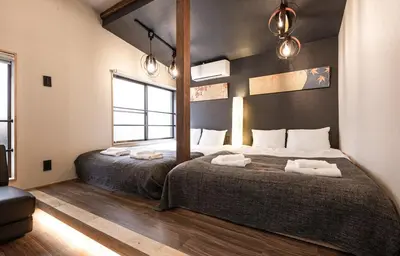 a bedroom with two beds with towels on them at The Villa Ebisu BLUE\u60e0\u6bd4\u5bff\u99c5\u5f92\u6b658\u5206 \u9759\u304b\u306a\u4f4f\u5b85\u5730 in Tokyo
