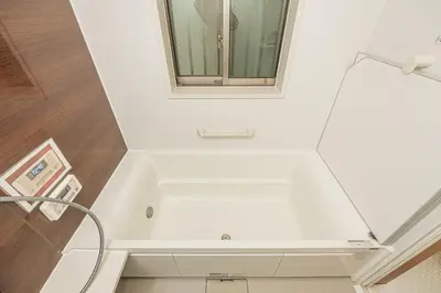 a white bath tub in a room with a window at Independent Home - One Minute Walk to Rail Hub - Direct Link to Asakusa Ueno Ginza Tokyo Sky Tower - 102 Square Meters with Four Rooms One Living Area Two Restrooms Two Baths - Easy Link to Both Major Airports in Tokyo