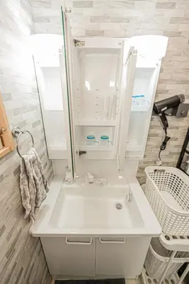 a bathroom with a white sink and a mirror at Independent Home - One Minute Walk to Rail Hub - Direct Link to Asakusa Ueno Ginza Tokyo Sky Tower - 102 Square Meters with Four Rooms One Living Area Two Restrooms Two Baths - Easy Link to Both Major Airports in Tokyo