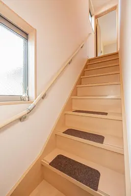 a staircase in a house with wooden stairs and a window at Independent Home - One Minute Walk to Rail Hub - Direct Link to Asakusa Ueno Ginza Tokyo Sky Tower - 102 Square Meters with Four Rooms One Living Area Two Restrooms Two Baths - Easy Link to Both Major Airports in Tokyo