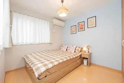 a small bedroom with a bed and a window at Independent Home - One Minute Walk to Rail Hub - Direct Link to Asakusa Ueno Ginza Tokyo Sky Tower - 102 Square Meters with Four Rooms One Living Area Two Restrooms Two Baths - Easy Link to Both Major Airports in Tokyo