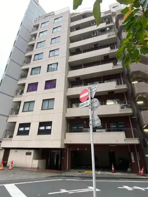 a tall building with a street sign in front of it at \u798f\u5c4b\u4e00\u756a\u9928 in Tokyo