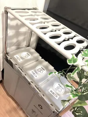 a stack of boxes in a room with a plant at Omori House in Tokyo