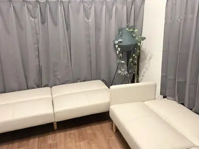 a living room with two white couches and a lamp at Omori House in Tokyo