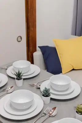 a table with white plates and silverware on it at Omori House in Tokyo