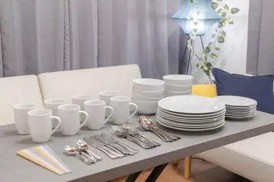 a table with white plates and silverware on it at Omori House in Tokyo