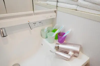 a bathroom with a sink with cups and toothbrushes at Near Skytree 90sqm 4BDR! 4mins to station! in Tokyo