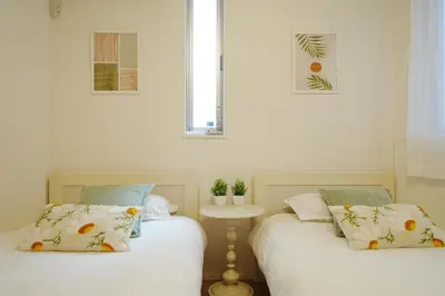 two beds sitting next to each other in a bedroom at Near Skytree 90sqm 4BDR! 4mins to station! in Tokyo