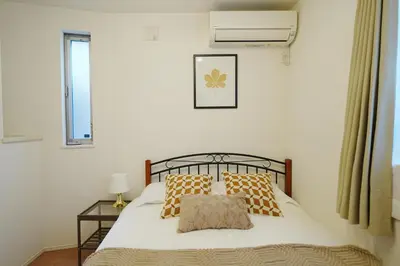 a bedroom with a bed with two pillows and a window at Near Skytree 90sqm 4BDR! 4mins to station! in Tokyo