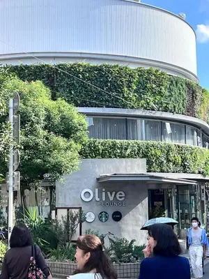 a group of people walking in front of a building at The Yumi Shinjuku in Tokyo
