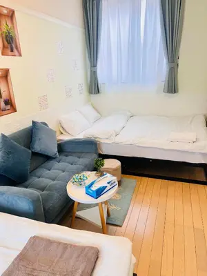 a living room with a couch and a table at The Yumi Shinjuku in Tokyo