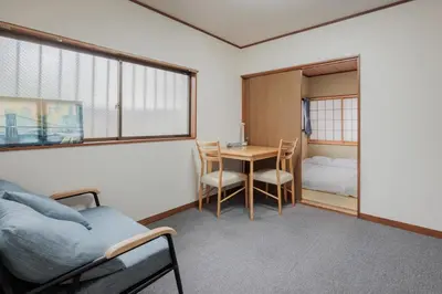 a small room with a table and a bed and a bedroom at self-check in-shinjuku-windhouse in Tokyo