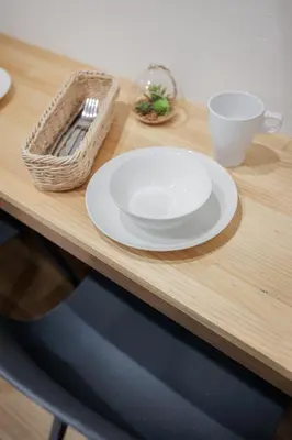 a table with a white plate and a basket on it at self-check in-shinjuku-windhouse in Tokyo