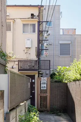 a house with a gate and a fence at self-check in-shinjuku-windhouse in Tokyo