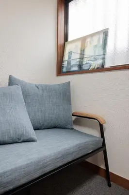 a couch sitting under a mirror in a room at self-check in-shinjuku-windhouse in Tokyo