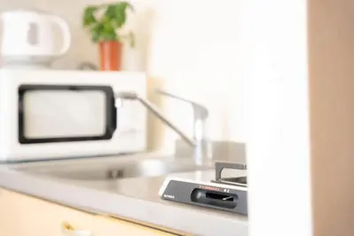 a kitchen counter with a sink and a microwave at P-Yamanote Line shinjuku \u9ad8\u7530\u99ac\u5834 5mins walk Hostel! \u9ad8\u901fWi-fi! Waseda in Tokyo