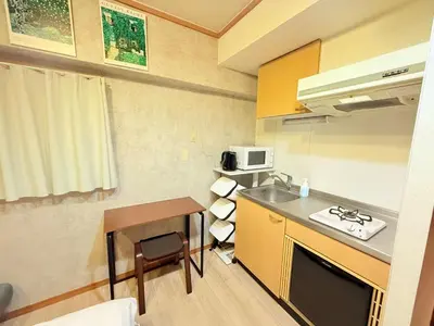 a small kitchen with a sink and a microwave at P-Yamanote Line shinjuku \u9ad8\u7530\u99ac\u5834 5mins walk Hostel! \u9ad8\u901fWi-fi! Waseda in Tokyo