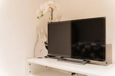 a flat screen tv sitting on top of a shelf at QiQi House Elegance in Sumida Yahiro Skytree Views & High-End Comfort for 6 people in Tokyo