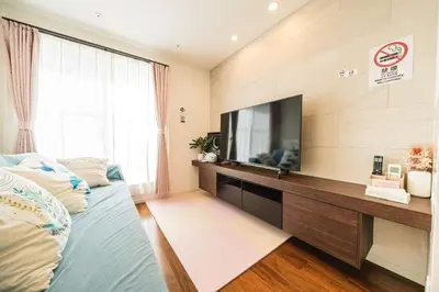 a living room with a television and a bed at QiQi House Elegance in Sumida Yahiro Skytree Views & High-End Comfort for 6 people in Tokyo