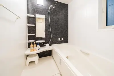 a white bathroom with a tub and a sink and a tub at QiQi House Elegance in Sumida Yahiro Skytree Views & High-End Comfort for 6 people in Tokyo