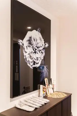 a bathroom mirror with a flower on top of a vanity at QiQi House Elegance in Sumida Yahiro Skytree Views & High-End Comfort for 6 people in Tokyo