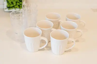 a group of white cups and glass vases at QiQi House Elegance in Sumida Yahiro Skytree Views & High-End Comfort for 6 people in Tokyo