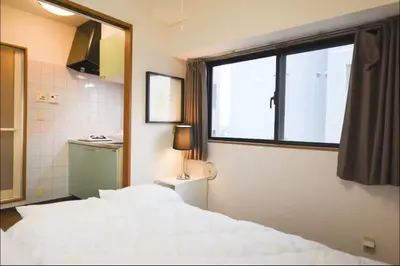 a bedroom with a white bed and a window at self-check in-\u30ef\u30b3\u30fc\u30c9\u76ee\u767d in Tokyo