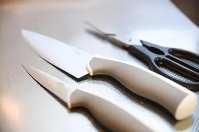 a pair of scissors sitting on top of a table at self-check in-\u30ef\u30b3\u30fc\u30c9\u76ee\u767d in Tokyo