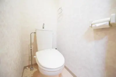a bathroom with a white toilet in a stall at self-check in-\u30ef\u30b3\u30fc\u30c9\u76ee\u767d in Tokyo