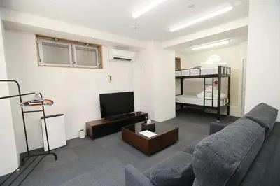 a living room with a couch and a bunk bed at SOKOResort Asakusa in Tokyo
