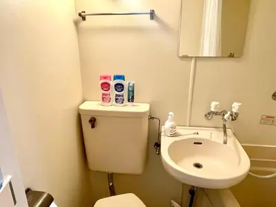 a small bathroom with a toilet and a sink at Tokyo West Shinjuku Entire House in Nishishinjuku-gochome in Tokyo