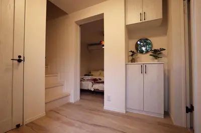 a room with a bedroom with a bed and a door at Urban House Koenji in Tokyo