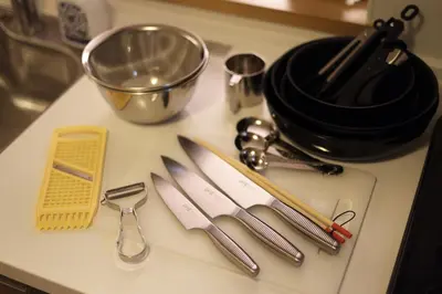 a kitchen counter with utensils on a counter top at Urban House Koenji in Tokyo