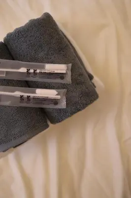 two thermometers sitting on top of a bed at Urban House Koenji in Tokyo