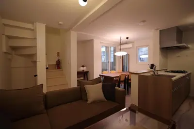 a living room and kitchen with a couch and a table at Urban House Koenji in Tokyo