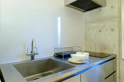 a kitchen with a sink and a counter top at DeLIGHT HOTEL in Tokyo