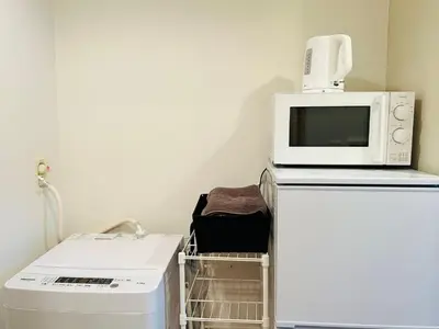 a microwave oven sitting on top of a refrigerator at Belle Lead in Tokyo