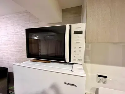 a microwave sitting on top of a white refrigerator at Terrace Tokyo Skytree in Tokyo