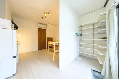 a kitchen and dining room with a staircase in a tiny house at Cozy 2-Floor Retreat near Ikebukuro - Easy Access to Central Tokyo - \u30a2\u30ad\u30b5\u30dd\u30b9\u30c6\u30a4\u672c\u84ee\u6cbc in Tokyo