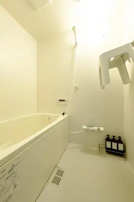 a white bathroom with a sink and a faucet at Cozy 2-Floor Retreat near Ikebukuro - Easy Access to Central Tokyo - \u30a2\u30ad\u30b5\u30dd\u30b9\u30c6\u30a4\u672c\u84ee\u6cbc in Tokyo