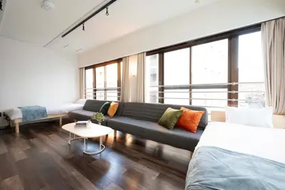 a living room with a couch and a table at Blossom House Akasaka 401 in Tokyo