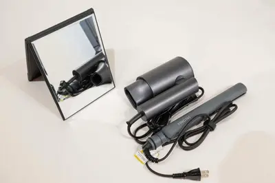 a black blow gun next to a mirror at Blossom House Akasaka 401 in Tokyo