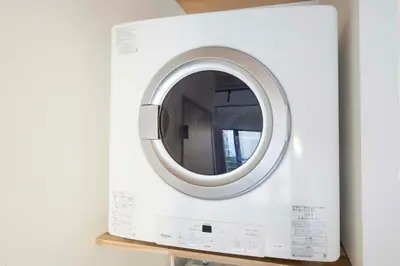 a white washing machine is on a shelf at Blossom House Akasaka 401 in Tokyo