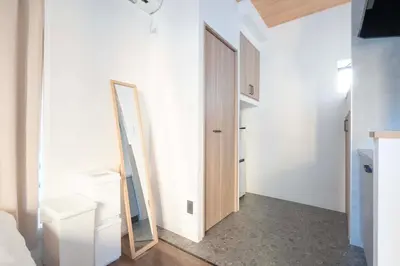 a mirror is on a wall next to a closet at Blossom House Akasaka 401 in Tokyo