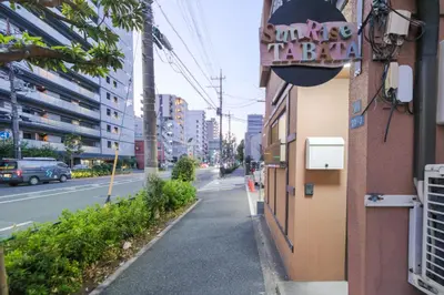 an empty street with a sign on the side of a building at \u30b5\u30f3\u30e9\u30a4\u30ba\u7530\u7aef\u65b0\u753a\u30cf\u30a6\u30b9 in Tokyo