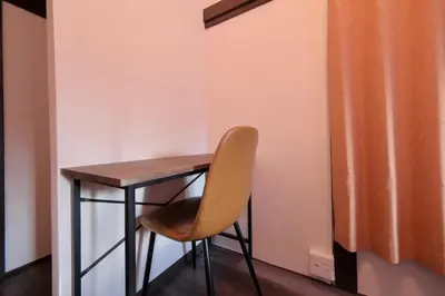 a chair sitting next to a desk in a room at \u30b5\u30f3\u30e9\u30a4\u30ba\u7530\u7aef\u65b0\u753a\u30cf\u30a6\u30b9 in Tokyo