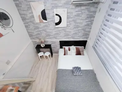 a small attic bedroom with a bed and a table at \u65b0\u5bbf\u4e2d\u5fc3\u5546\u5708-\u65b0\u5927\u4e45\u4fdd\u5f92\u6b654\u5206-\u65b0\u5bbf\u5f92\u6b6510\u5206-2Room-Max4P in Tokyo