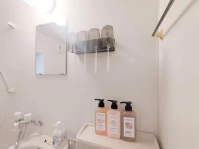 a bathroom with three bottles of soap and a mirror at \u65b0\u5bbf\u4e2d\u5fc3\u5546\u5708-\u65b0\u5927\u4e45\u4fdd\u5f92\u6b654\u5206-\u65b0\u5bbf\u5f92\u6b6510\u5206-2Room-Max4P in Tokyo
