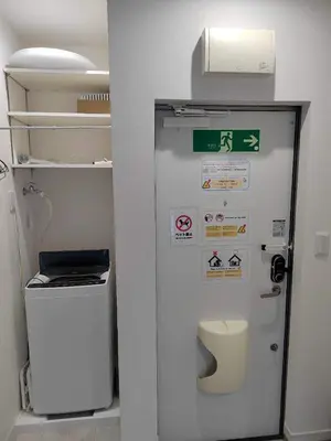 a bathroom with a toilet and a refrigerator at \u6771\u4eac\u5929\u7a7a\u4e4b\u5bb6\u6c11\u5bbf201\u72ec\u7acb\u516c\u5bd3 \u72ec\u7acb\u536b\u6d74 in Tokyo