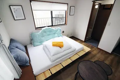 a small bedroom with a white bed and a window at nakano102 in Tokyo